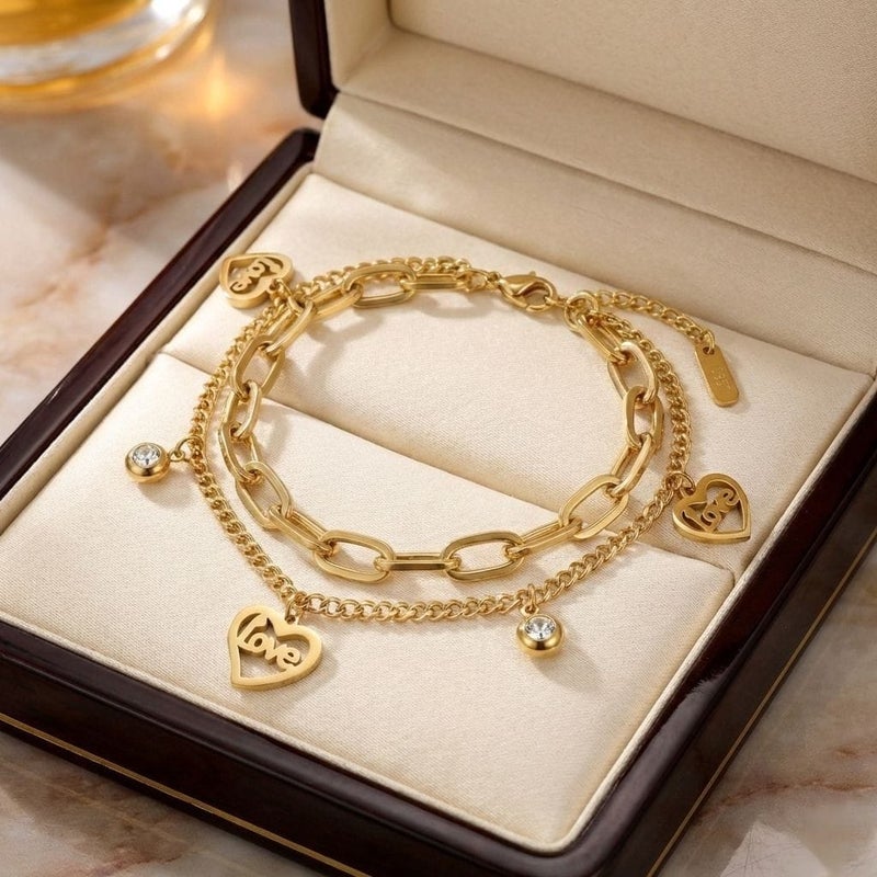 A gold bracelet made of rust-resistant stainless steel, with two layers of chains, heart-shaped pendants filled with the word Love with shiny stones, and an adjustable clasp to fit you. - Image 5